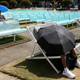 Spectators shielding themselves from the heat at Garden Square in Melbourne during the Australian Open tennis championships on Jan. 25, 2018.